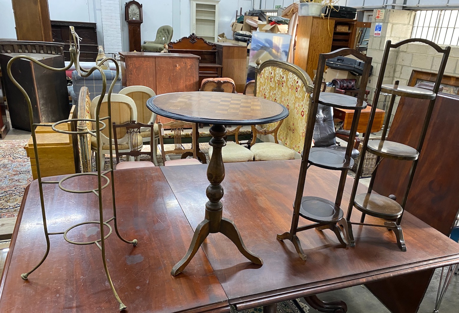A Victorian style circular tripod games table, diameter 51cm, height 66cm together with three cake stands